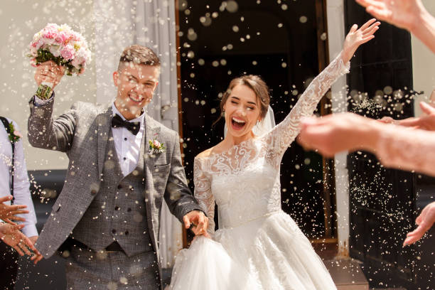 Wedding scene with couples smiling and waving