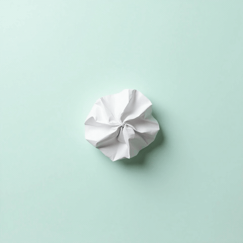 Crumpled paper unfolding flat to reveal handwritten Sorry text, animated sincere sorry GIF