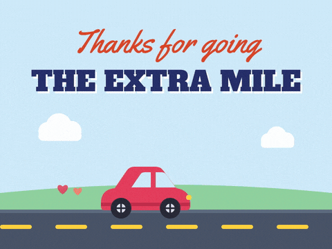 Thanks for going the extra mile appreciation with a red car driving past a heart road sign