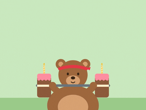 Birthday gains with a brown bear in a red headband lifting a barbell made of two birthday cakes