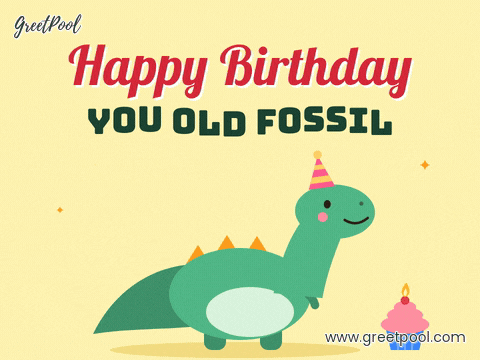 Happy Birthday you old fossil joke with a smiling green dinosaur in a party hat nodding beside a cupcake