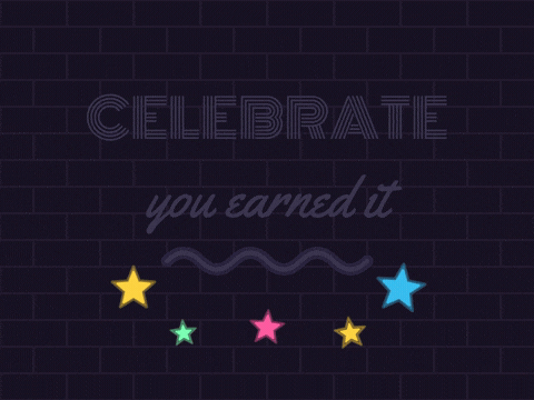 Celebrate in blue neon letters flickering on with you earned it in pink neon script on a brick wall