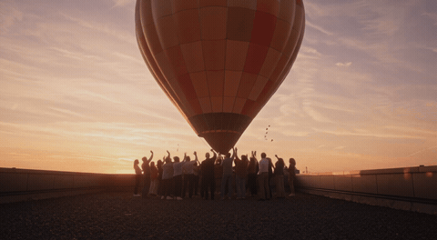 Hot air balloon drifting at sunset with We’ll Miss You message, animated farewell GIF