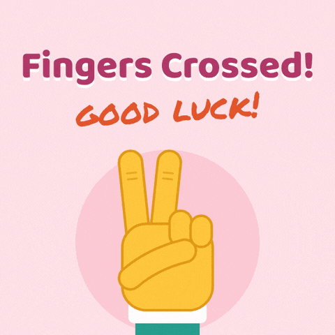 Fingers crossed good luck hand crossing two fingers with sparkles on a pink background
