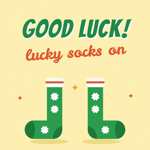 Good luck lucky socks on, a pair of green clover socks dancing on a yellow background