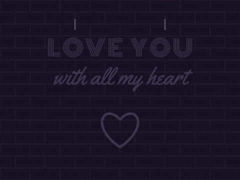 Love you with all my heart in pink and yellow neon flickering on above a glowing neon heart on brick