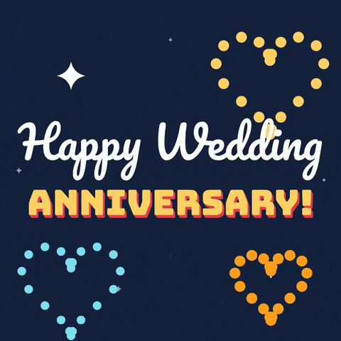 Happy wedding anniversary message with heart-shaped fireworks bursting across a navy night sky