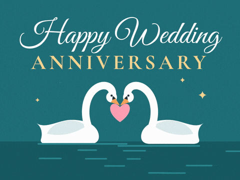 Happy wedding anniversary wish with two white swans forming a heart with their necks on a teal lake