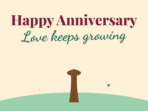 Happy anniversary, love keeps growing message with a tree sprouting pink and red heart leaves