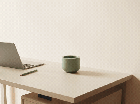 Minimalist office desk with plants and photos and a Welcome To The Team message, animated welcome GIF