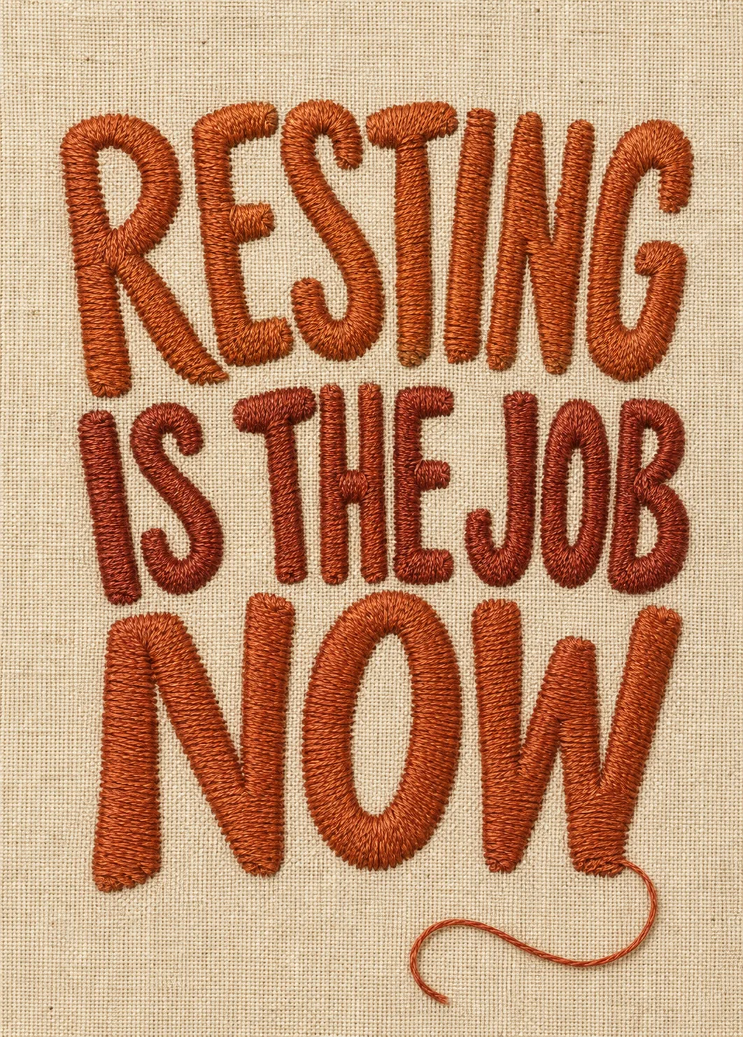 Rust orange embroidered lettering reading 'Resting Is the Job Now' stitched on cream linen fabric Rust orange embroidered lettering reading 'Resting Is the Job Now' stitched on cream linen fabric