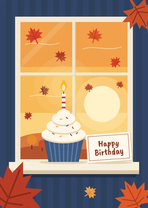Cupcake with a lit candle on a windowsill with autumn leaves outside and a Happy Birthday note